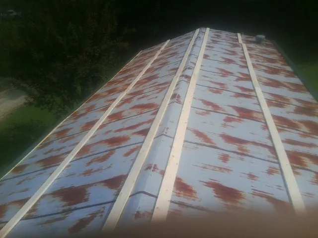 Rusted metal roof panels with new wood purlins before replacement — Storm Damage Roof Repair in Moore by Roofing Brothers