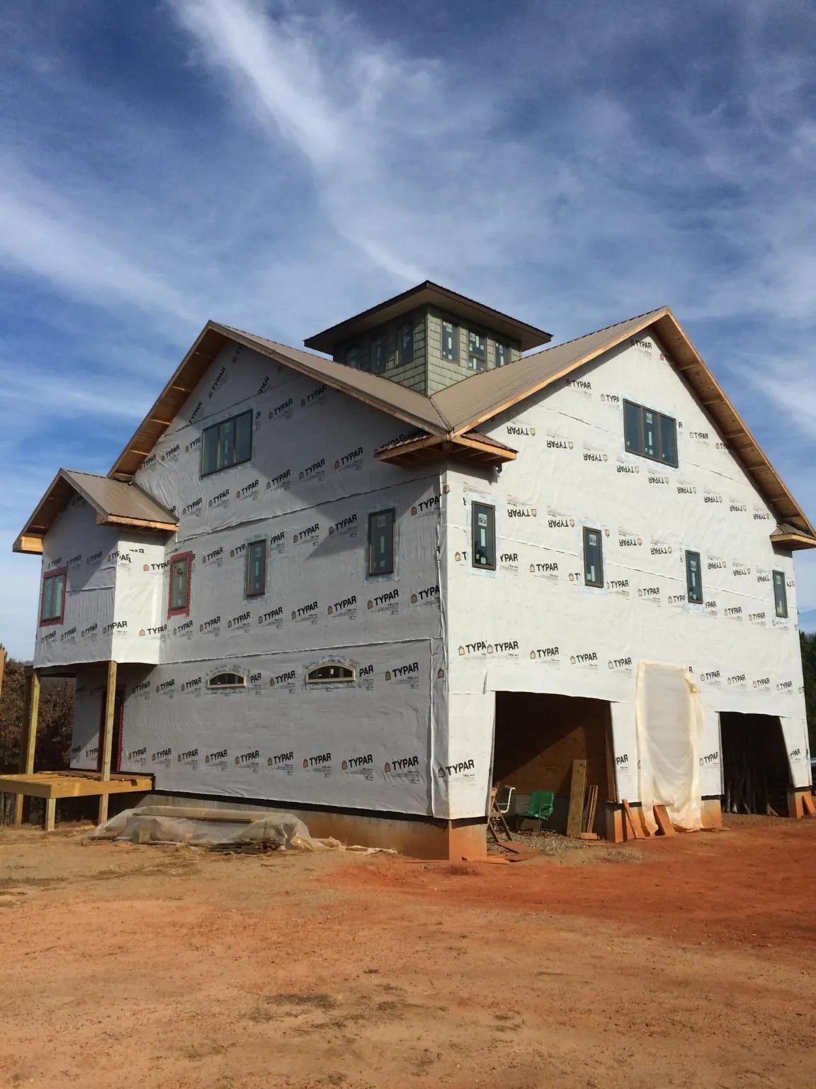 New two story house under construction with a cupola and gabled roofs in Moore